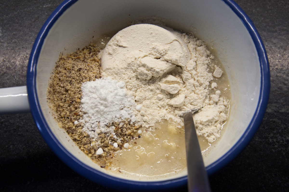 mashed bananas, flour, ground almonds, and baking powder in bowl