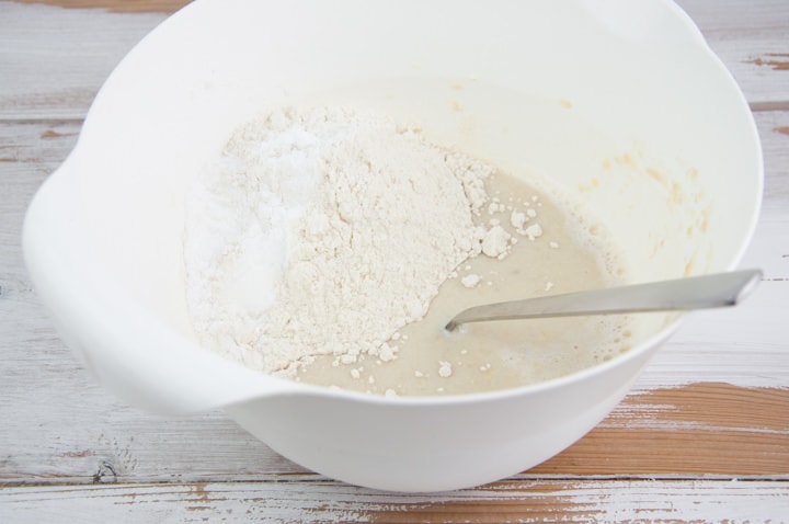 wet and dry ingredients for the vegan blueberry pancakes in a bowl