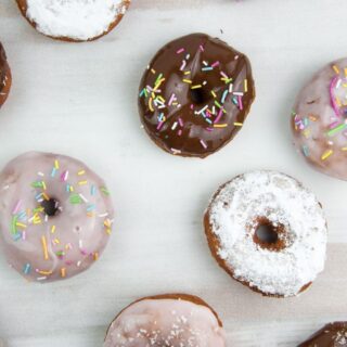 various vegan donuts with chocolate, pink glaze, powdered sugar, and sprinkles