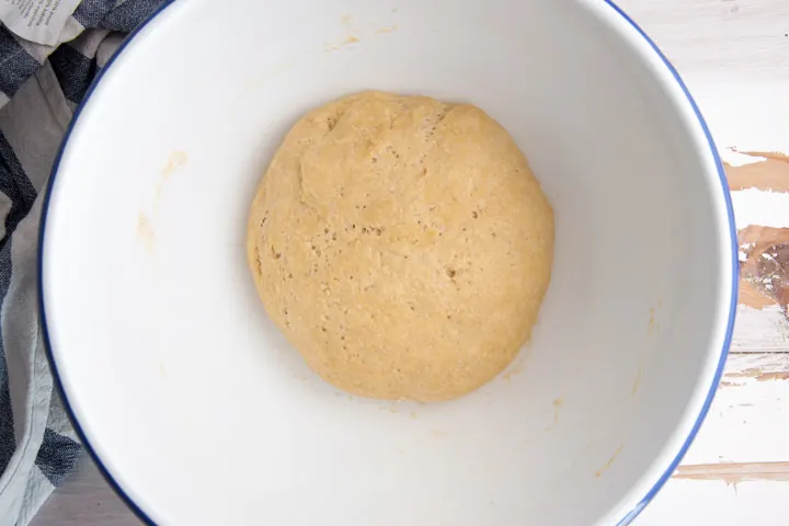 donut dough in a bowl after rising