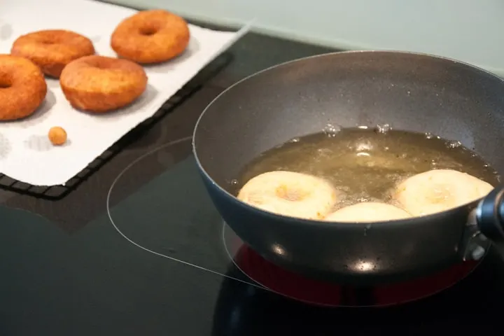 frying donuts in a wok