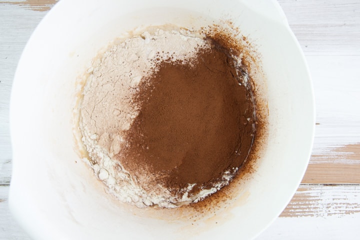 flour, cocoa powder, and baking powder in a bowl with the wet ingredients