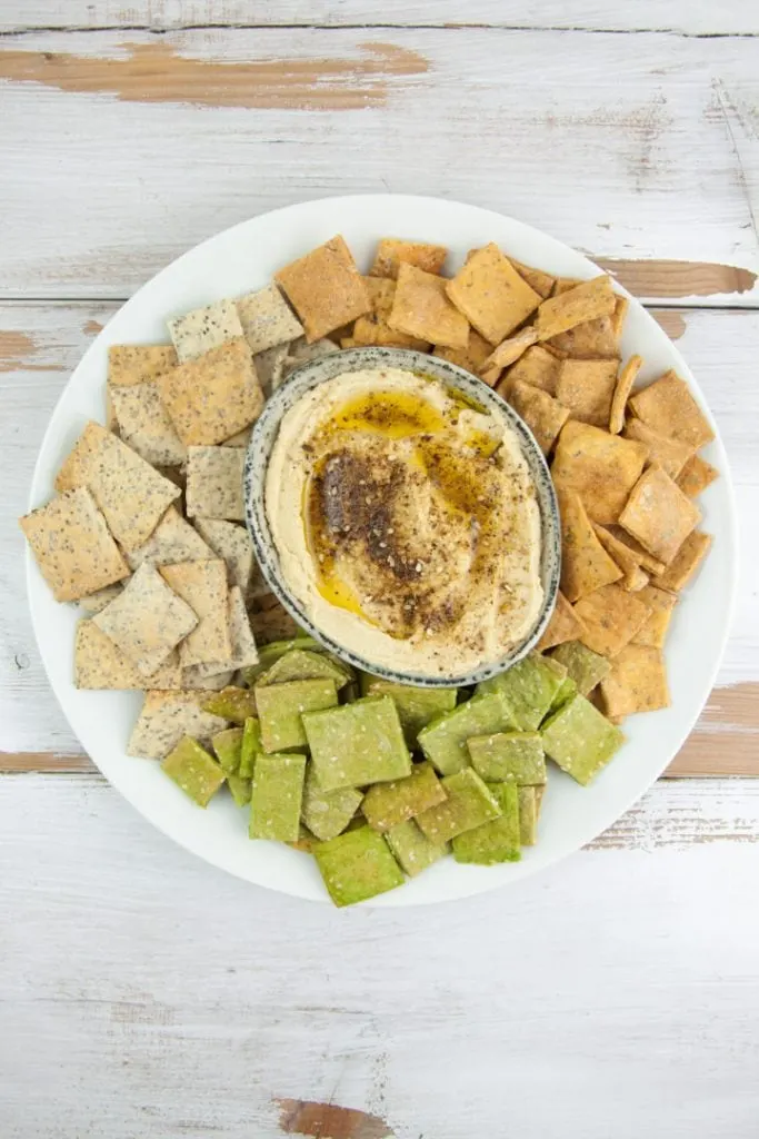 Za'atar Hummus served with pizza, spinach and poppy seed crackers