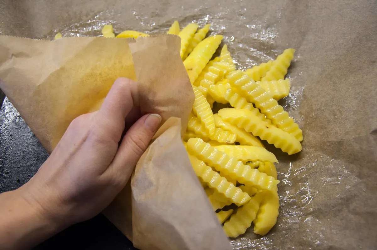 crinkle cut fries on parchment paper