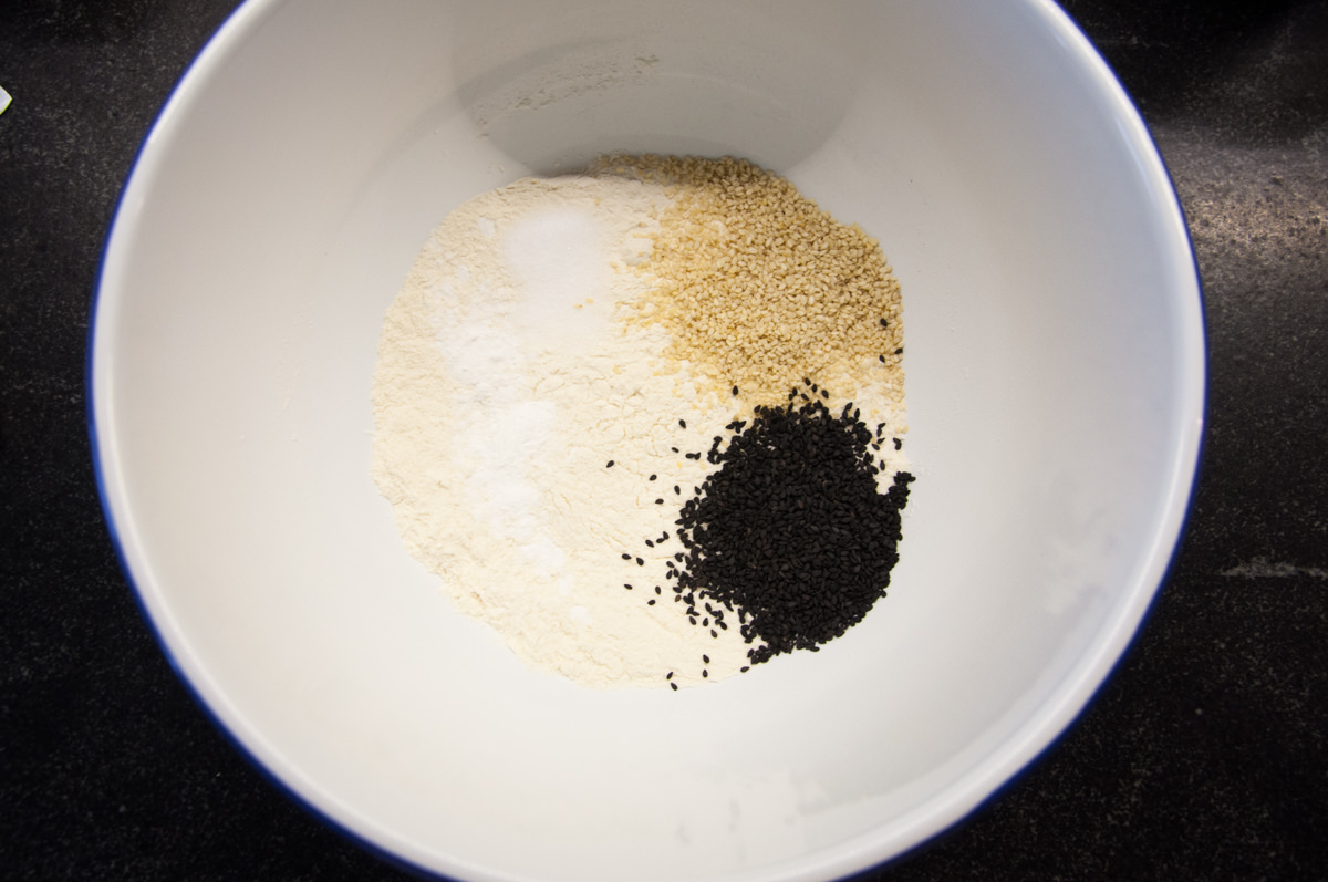 flour, salt, baking powder, sesame seeds in bowl