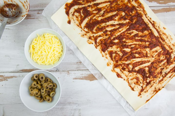 puff pastry spread with tomato sauce