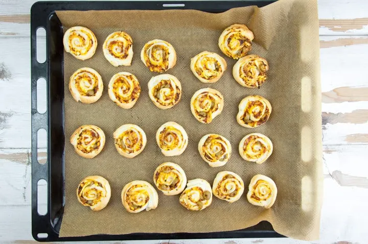 Vegan Pizza Pinwheels with olives on a baking tray