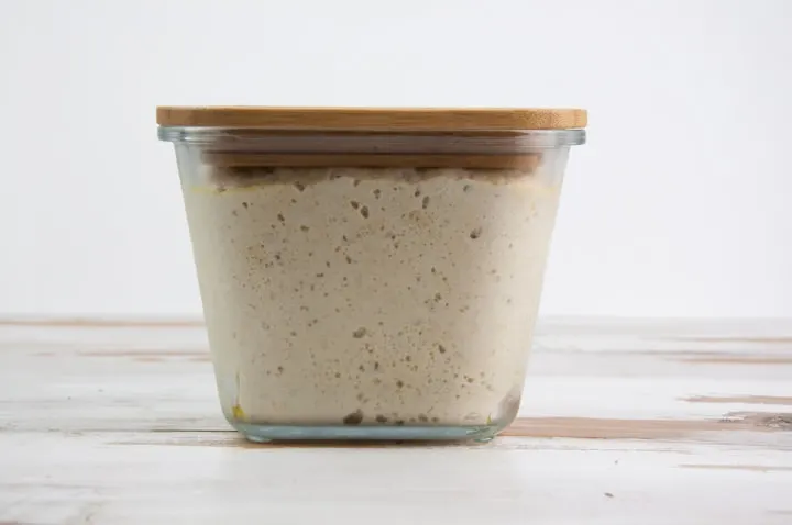 Risen yeast dough in glass container