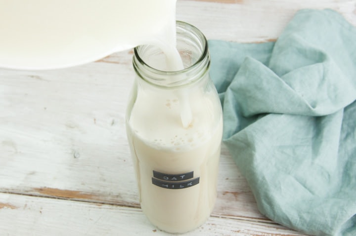 pouring oat milk into bottle