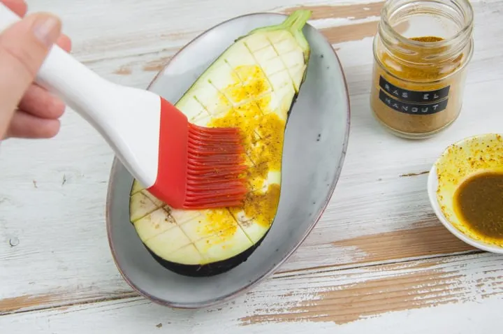 brushing eggplant with ras el hanout and oil