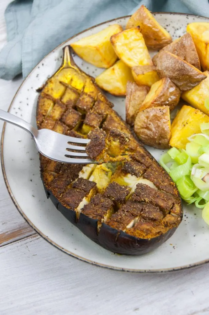 fork digging into oven-roasted eggplant