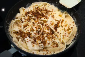 Vegan Cashew Carbonara Pasta with TVP Bacon in the pan