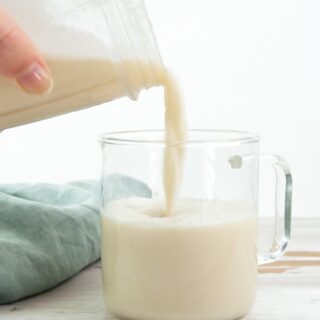 pouring sesame milk into a glass