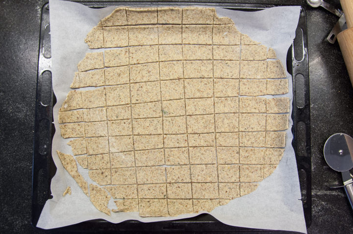 unbaked crackers on parchment paper