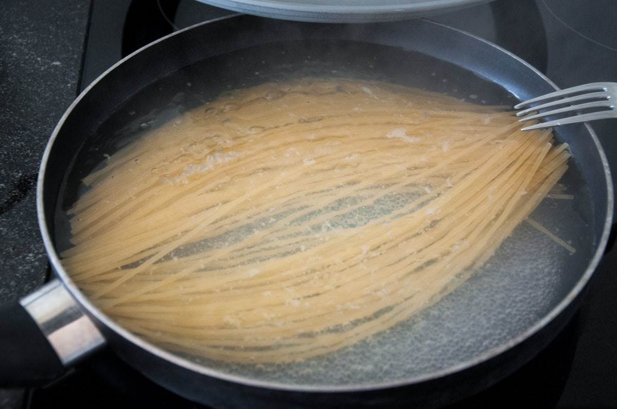 cooking spaghetti in pan