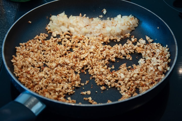 onions, garlic and tempeh in pan