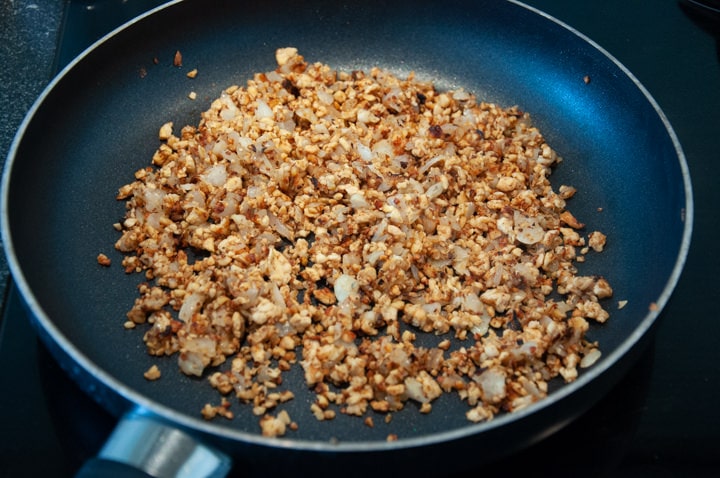 onions, garlic and tempeh in pan
