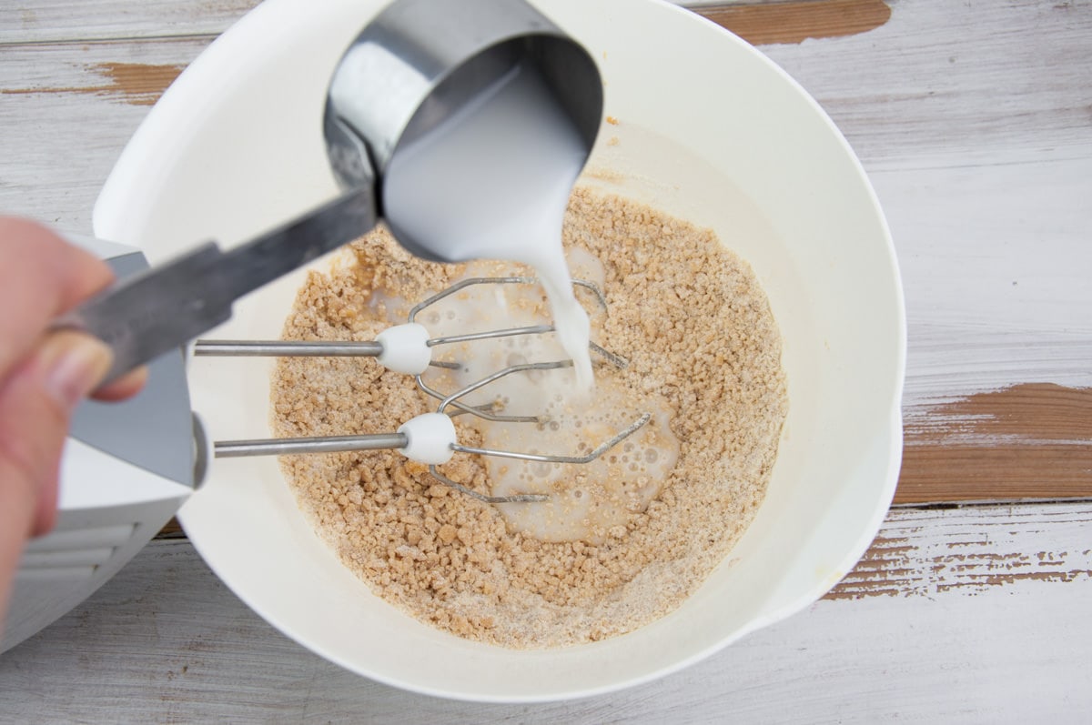 adding milk to peanut butter cookie dough