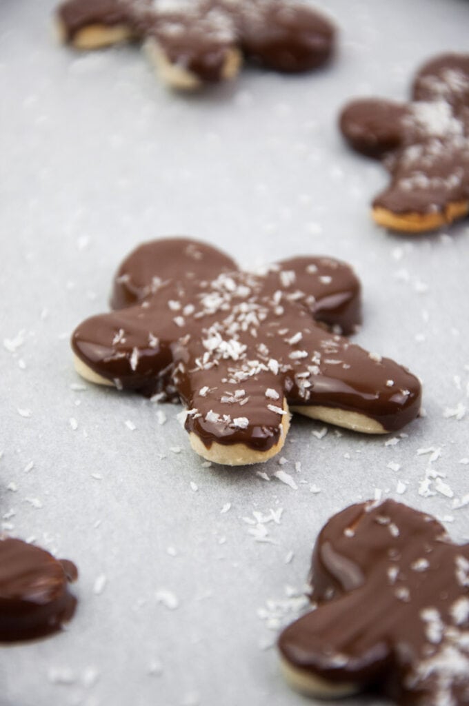 almond butter sugar cookies with chocolate coating and shredded coconut