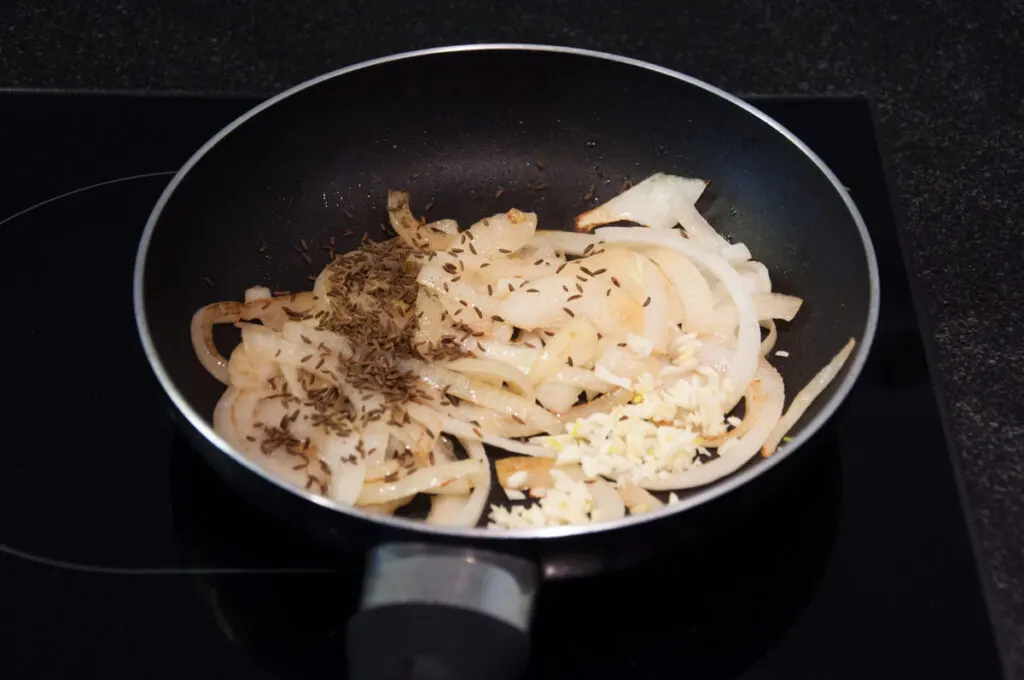 onion, garlic, spices in pan