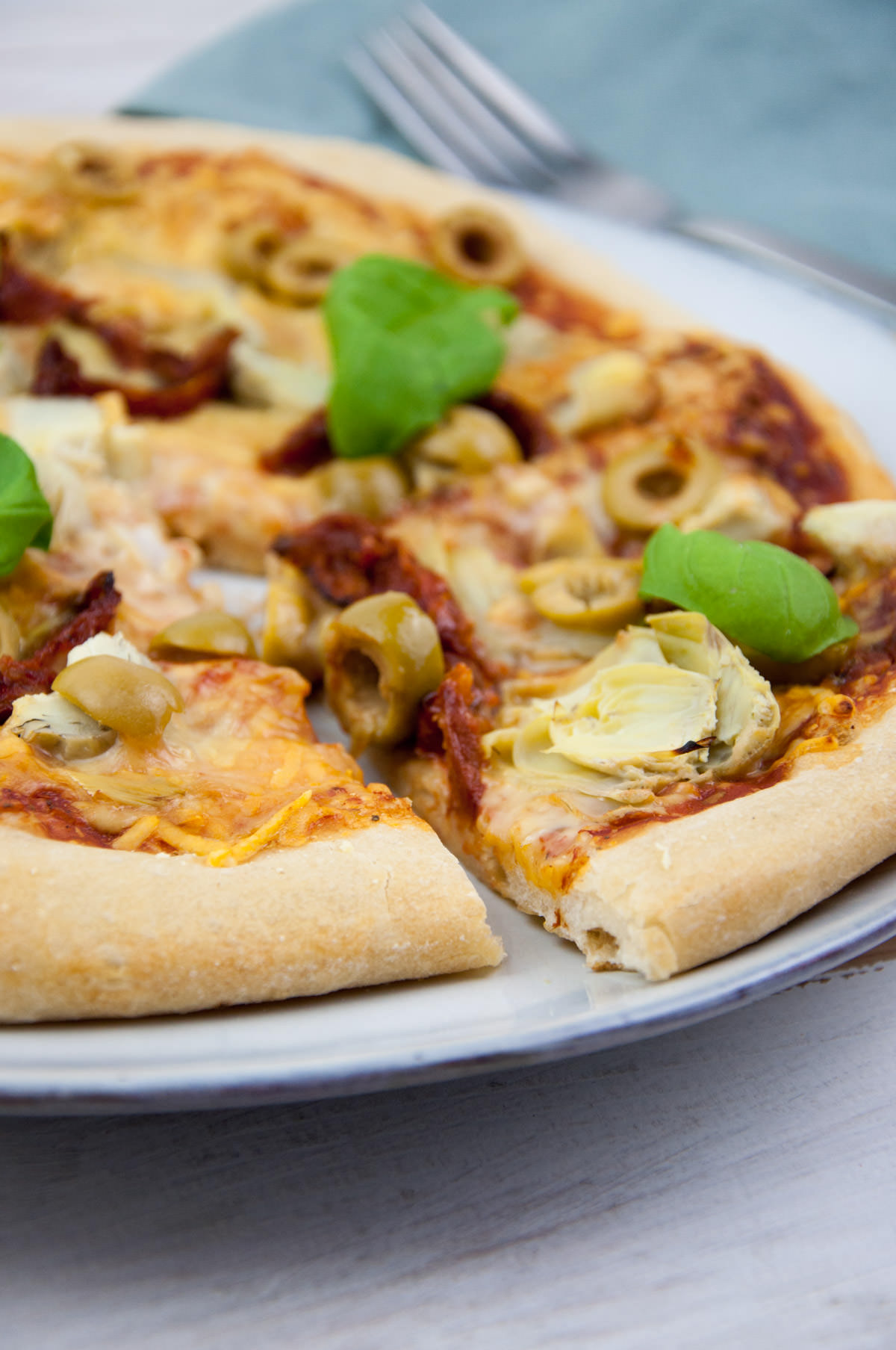 antipasti pizza with olives, artichokes, and sun-dried tomatoes