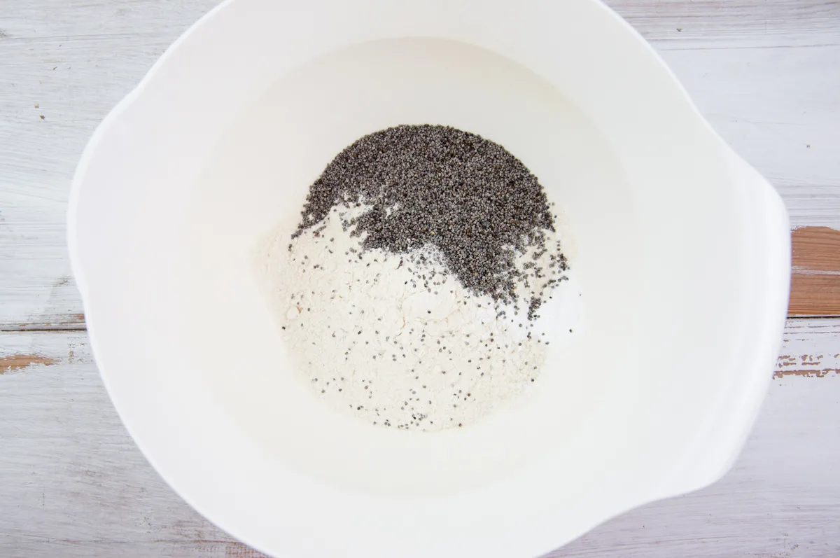 flour, baking powder, and poppy seeds in bowl