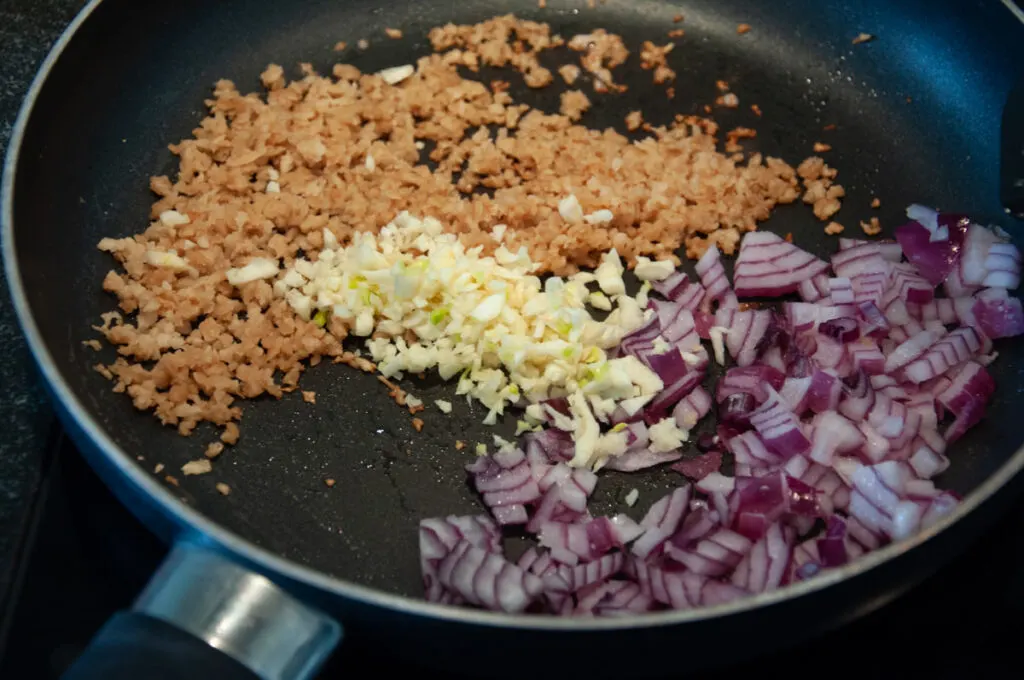 soy granule, onion, and garlic in pan