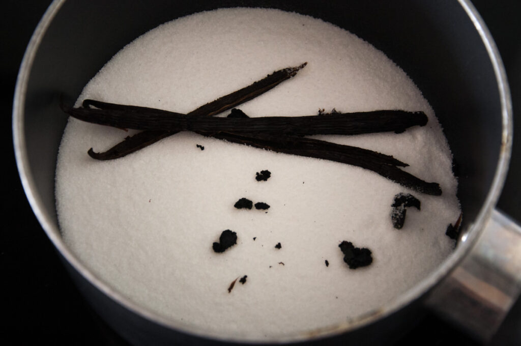 vanilla beans and sugar in pot