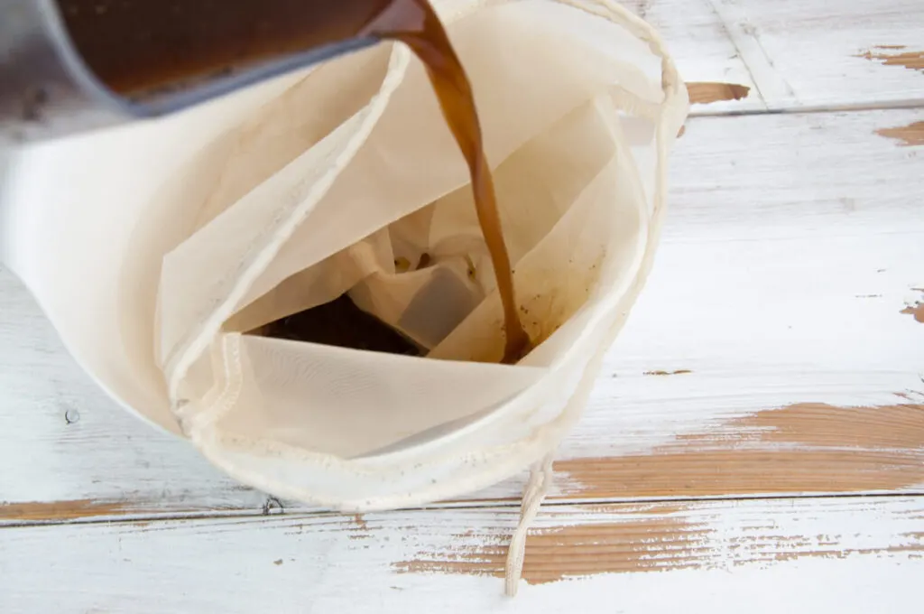 pouring coffee in nut milk bag