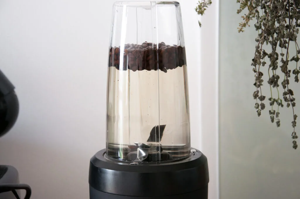 coffee beans and water in blender