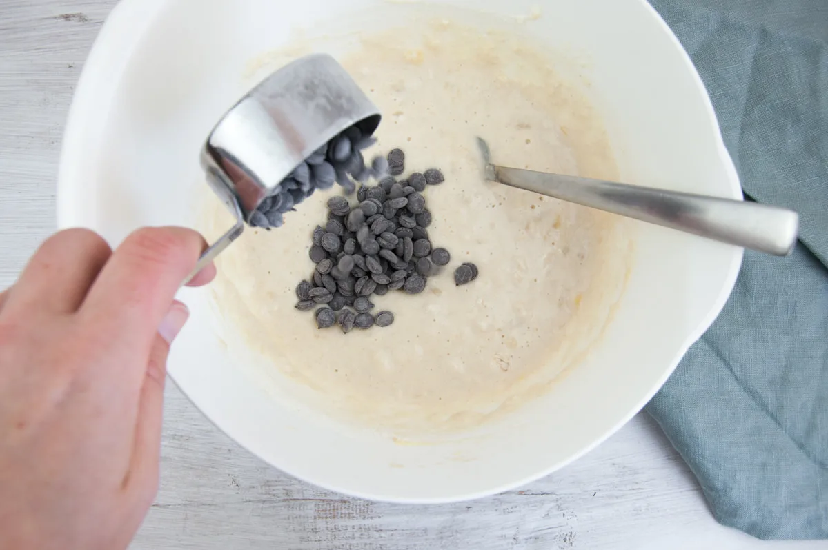 adding chocolate chips into pancake batter