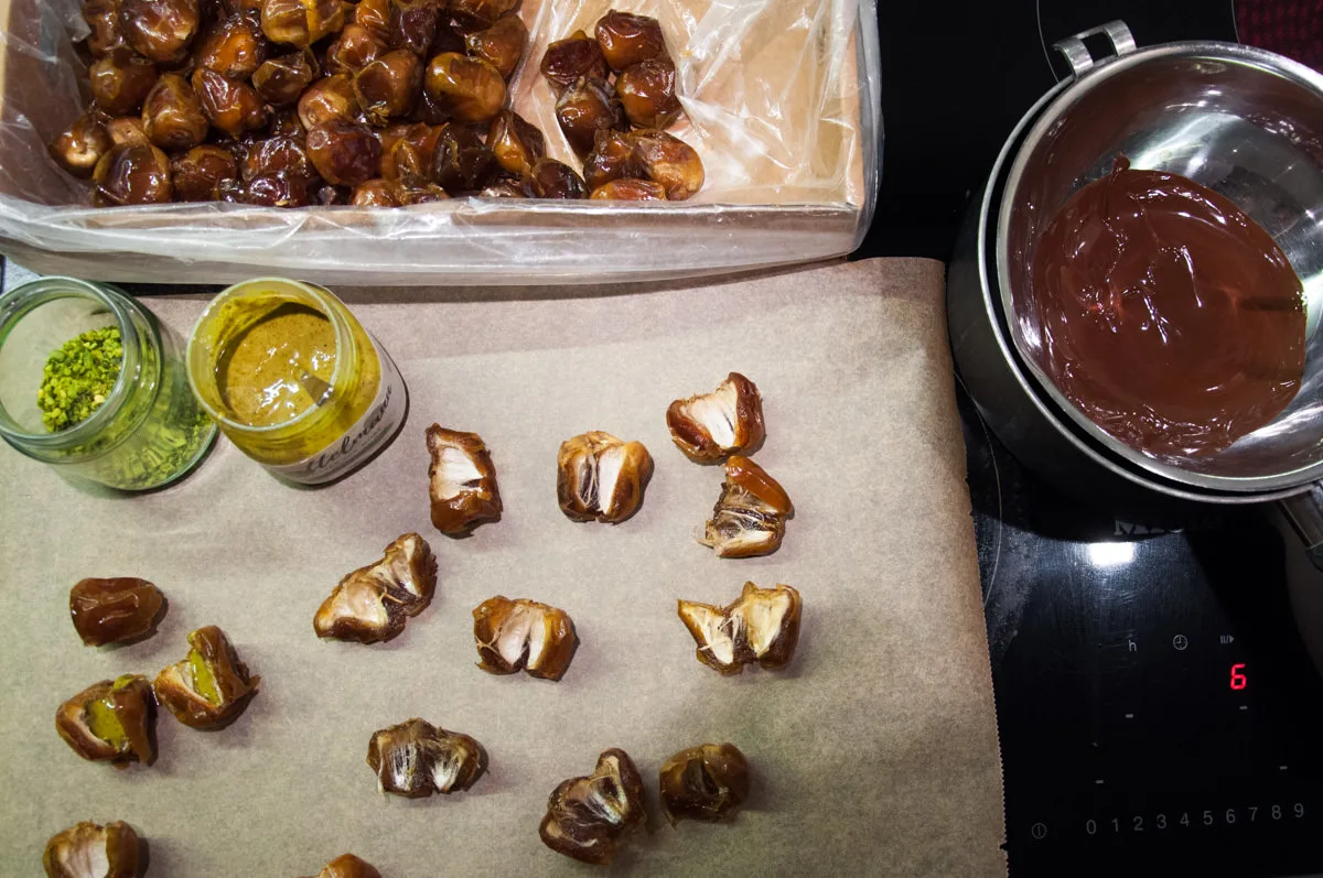 dates, pistachio butter, chopped pistachios and melted chocolate