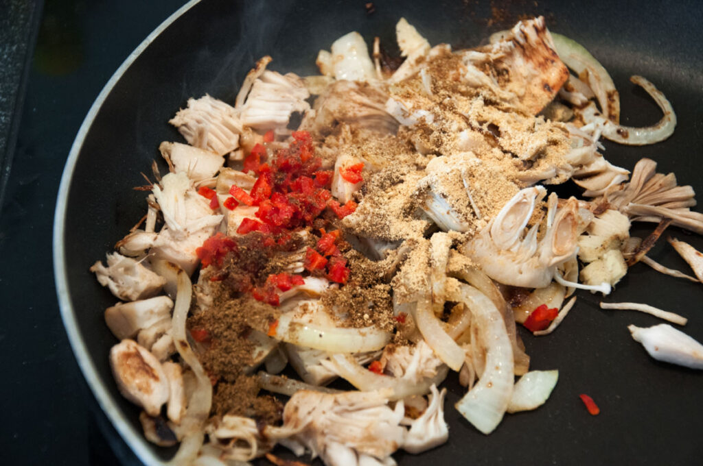 onions, jackfruit and spices in pan