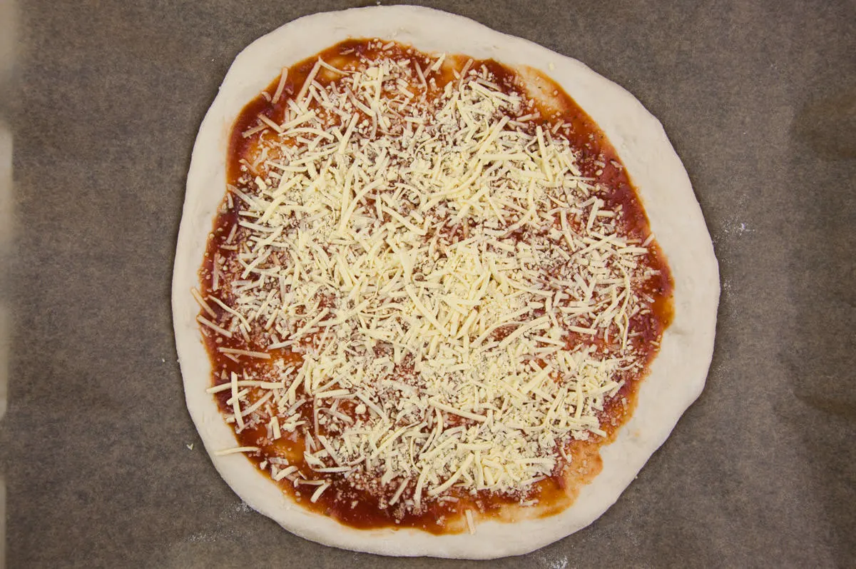 pizza crust with tomato sauce and vegan cheese