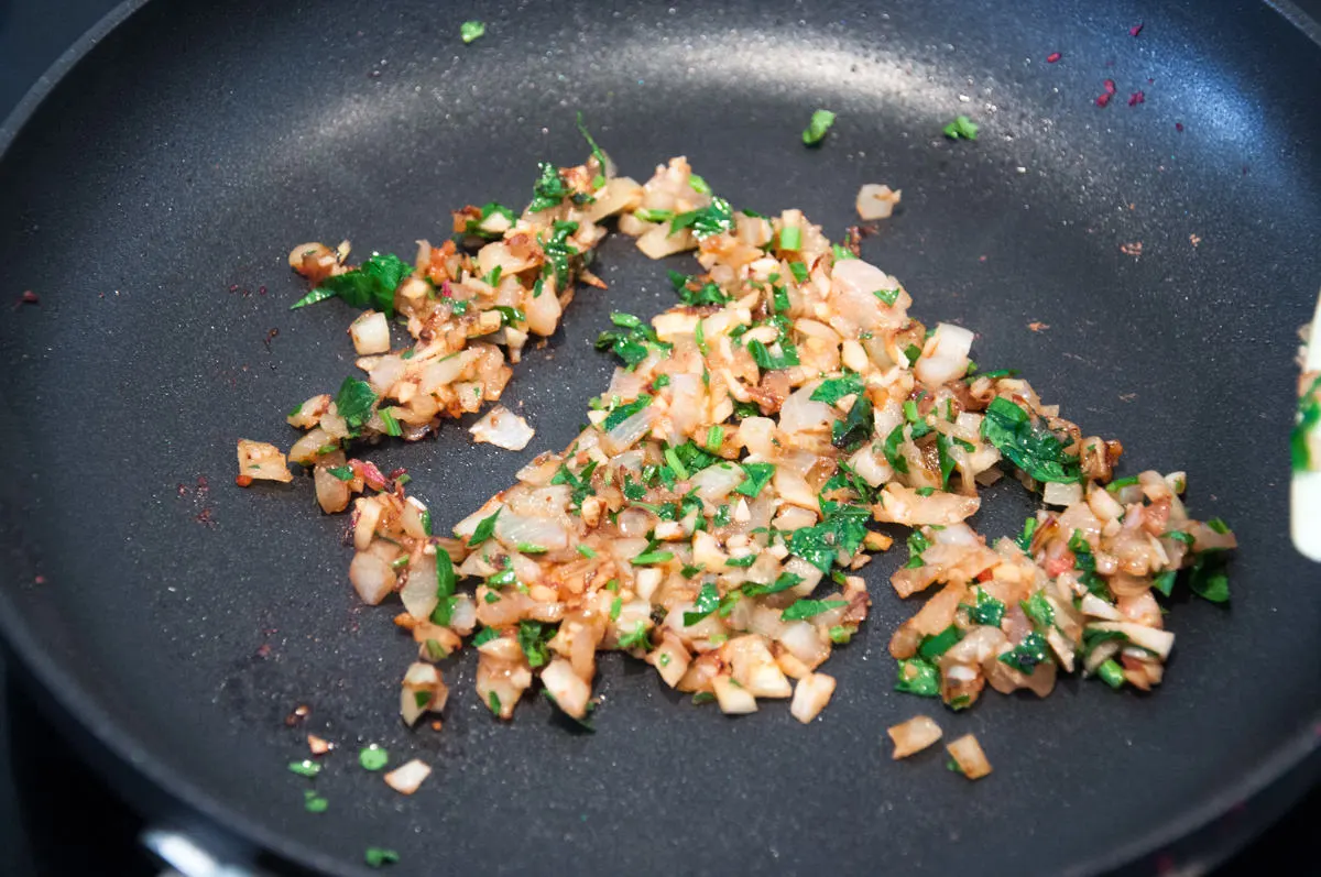 onion, garlic and parsley in a pan