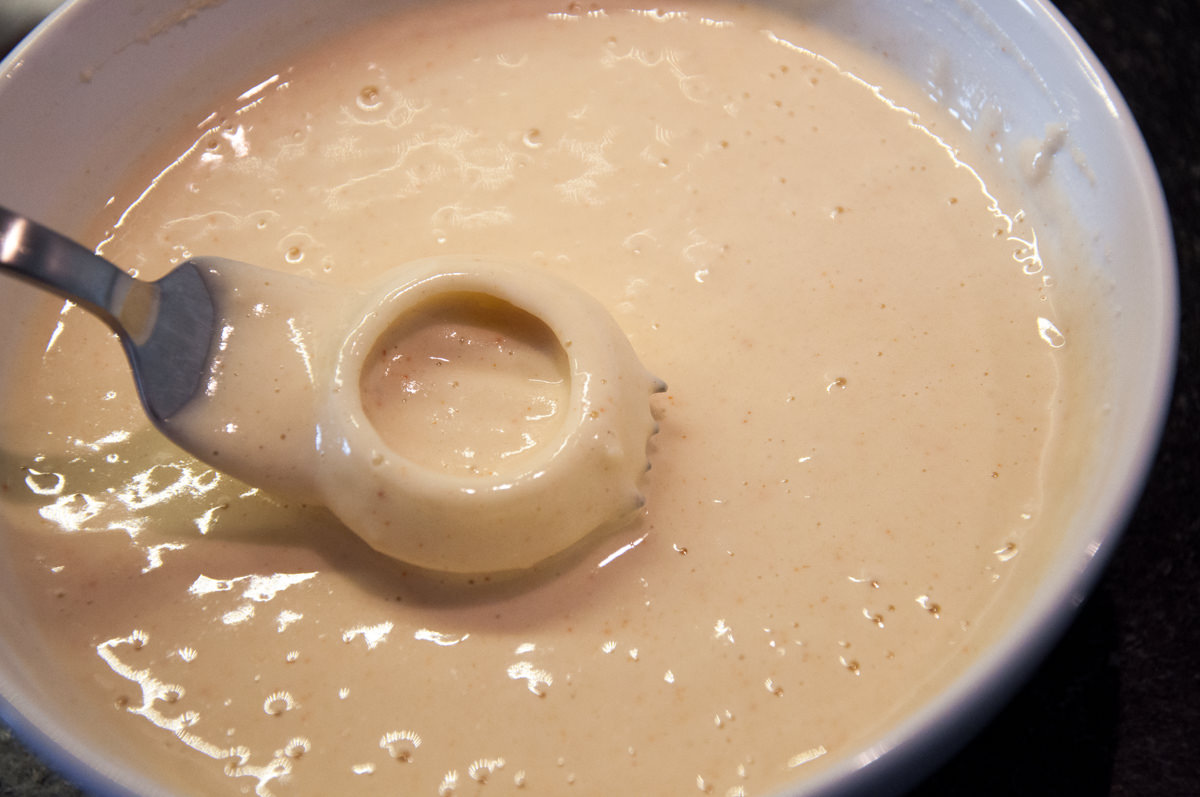 dipping onion ring in batter