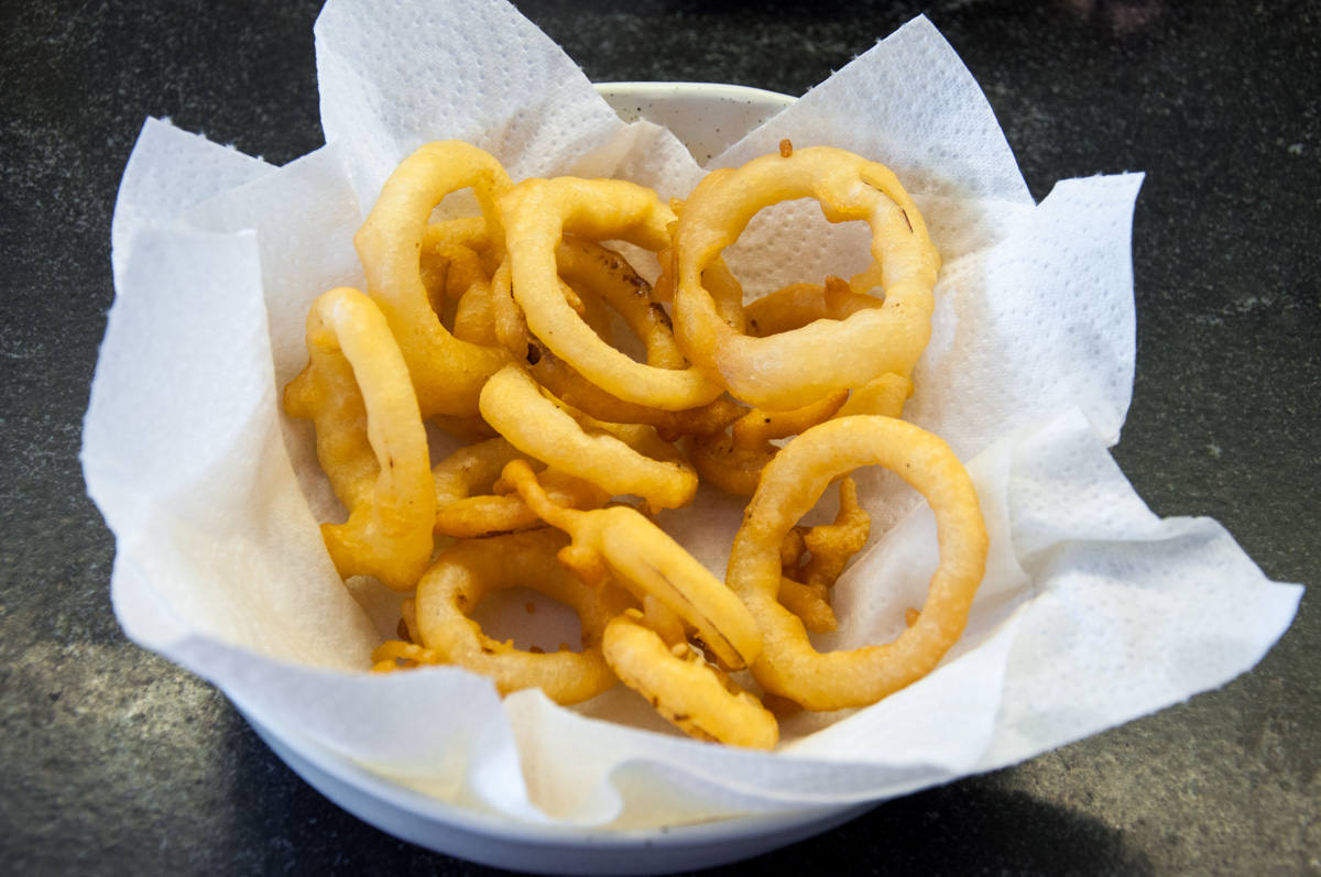 fried onion rings on paper towels