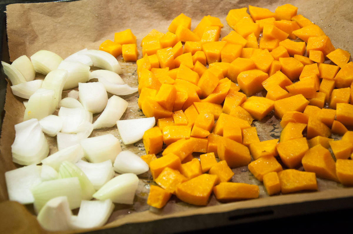 pumpkin cubes and onion on baking tray