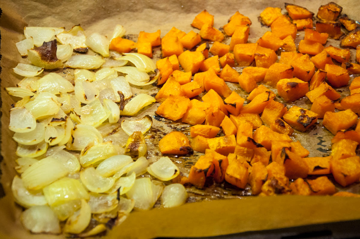 pumpkin cubes and onion on baking tray