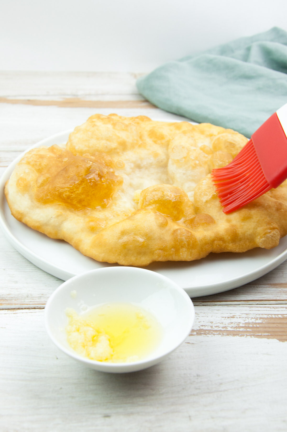 brushing langos with garlic oil