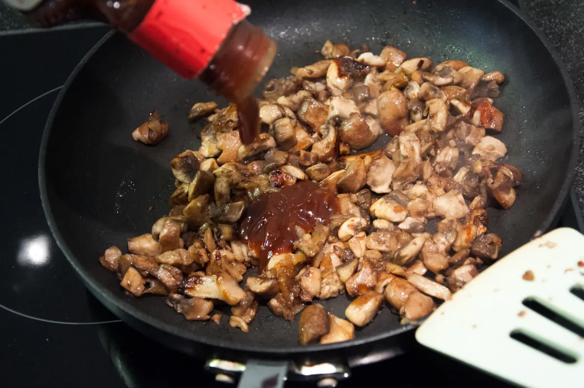mushrooms in pan with onion and bbq sauce