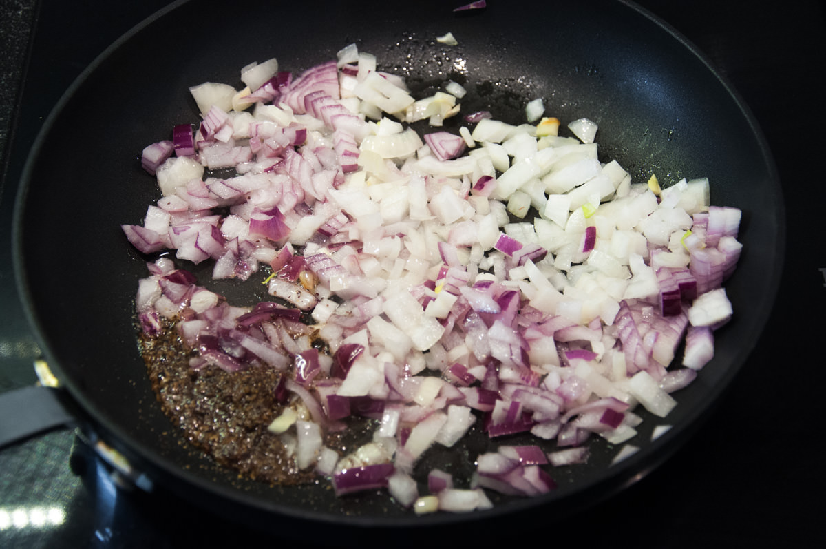 chopped onions in pan with spices