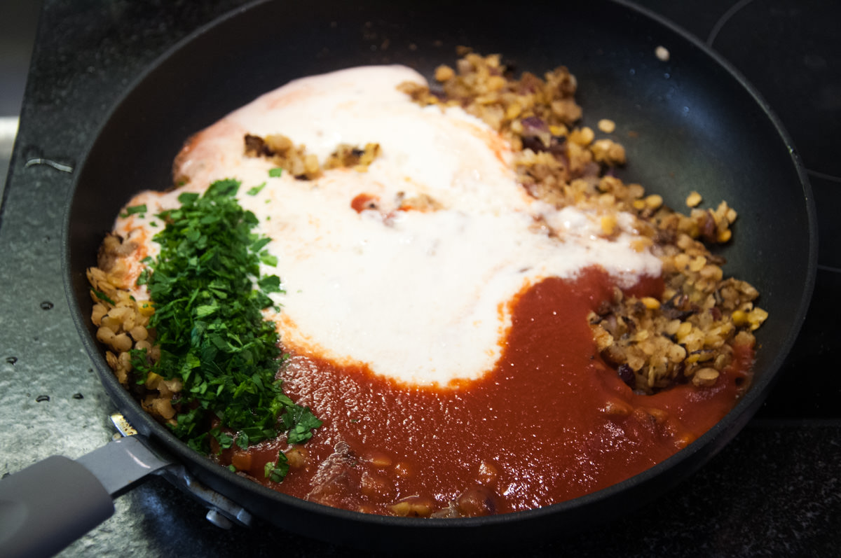 lentils, cashew cream, tomato passata and parsley in pan