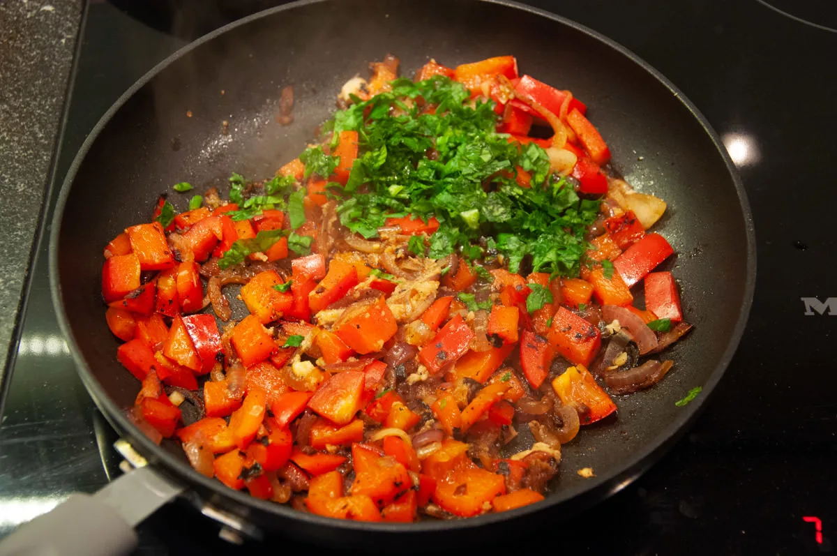 bell pepper, onions, parsley in pan