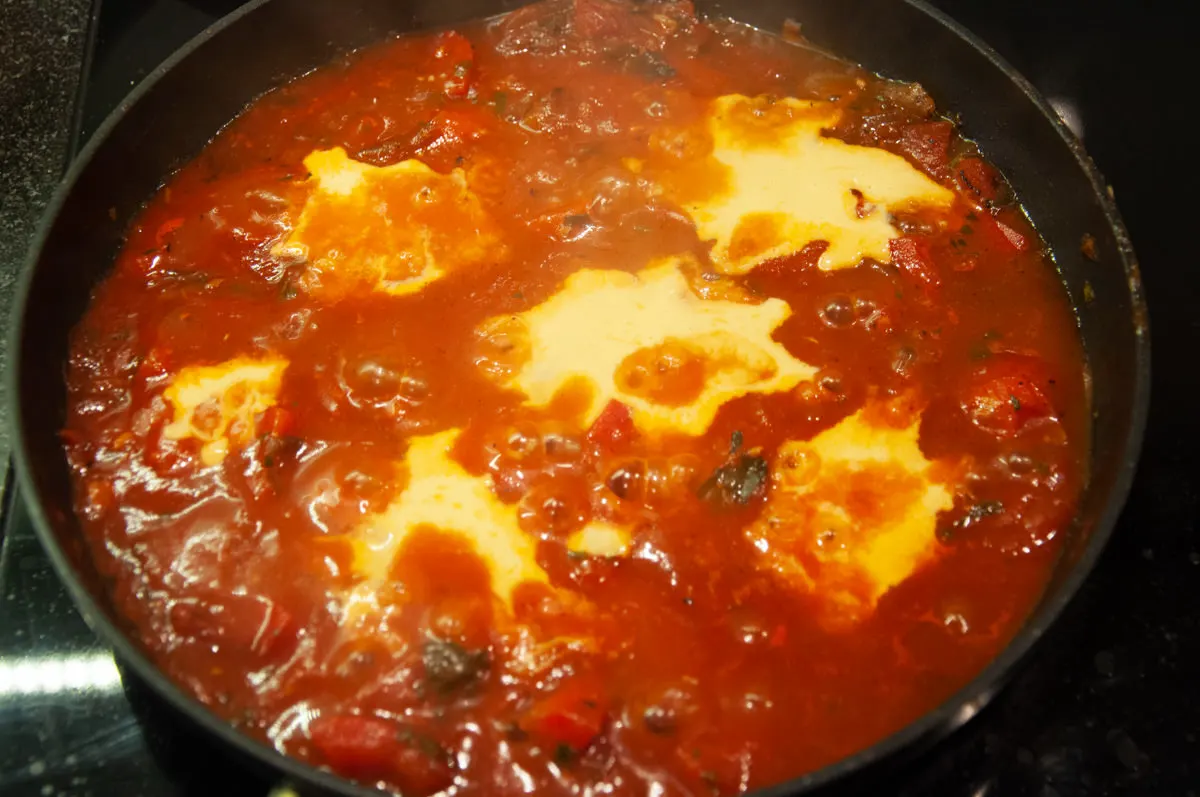 Vegan Shakshuka with chickpea 'eggs' in pan