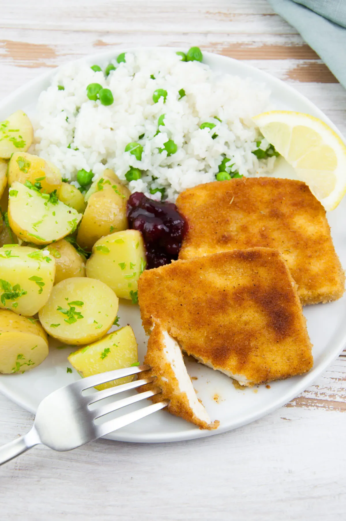 Tofu Schnitzel served with rice+peas and buttered parsley potatoes