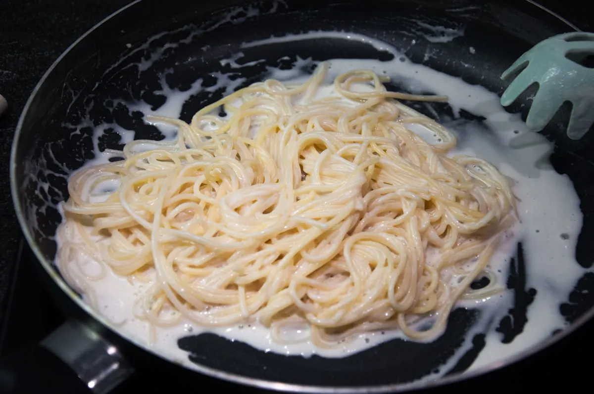 spaghetti and cashew cream in pan